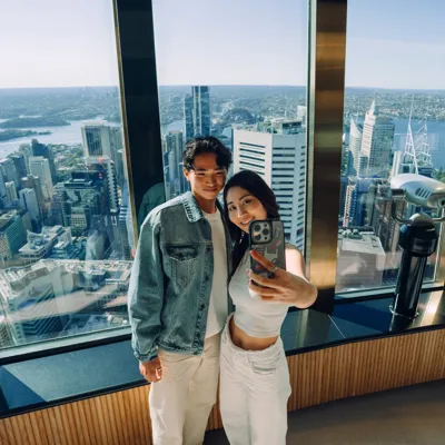Couple posing for a selfie at observation deck window